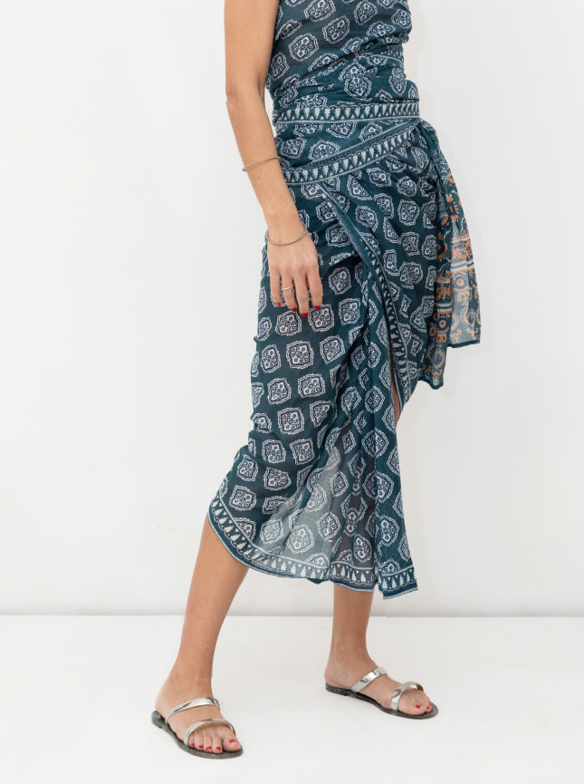 The ByGungur blue and white block print wrap dress is worn as a strapless wraparound dress. It's wrapped to give an asymetric skirt and a strapless top part.