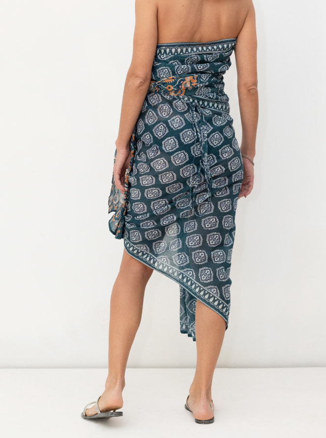 The ByGungur blue and white block print wrap dress is worn here as a strapless bandeu wrap dress back view