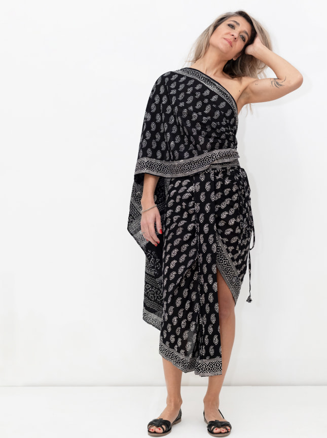 The ByGungur black and white block print maxi wrap dress is worn here as a one shoulder dress. Wrapped around the waist to give an asymetric skirt it's then wrapped around the chest and draped over the left shoulder. It can be pinned in place at the shoulder or at the back, or left to hang free.