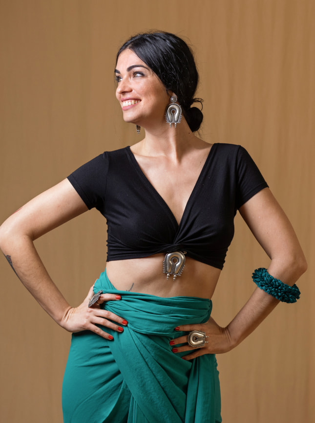 The ByGungur Pearl Crop is a versatile crop top that can be adapted to wear in different ways. Here it's worn as a V neck crop top with the plunging cutaway at the front. A sexy look it finished just under the bust. Here the model is wearing it with the ByGungur wrap skirt