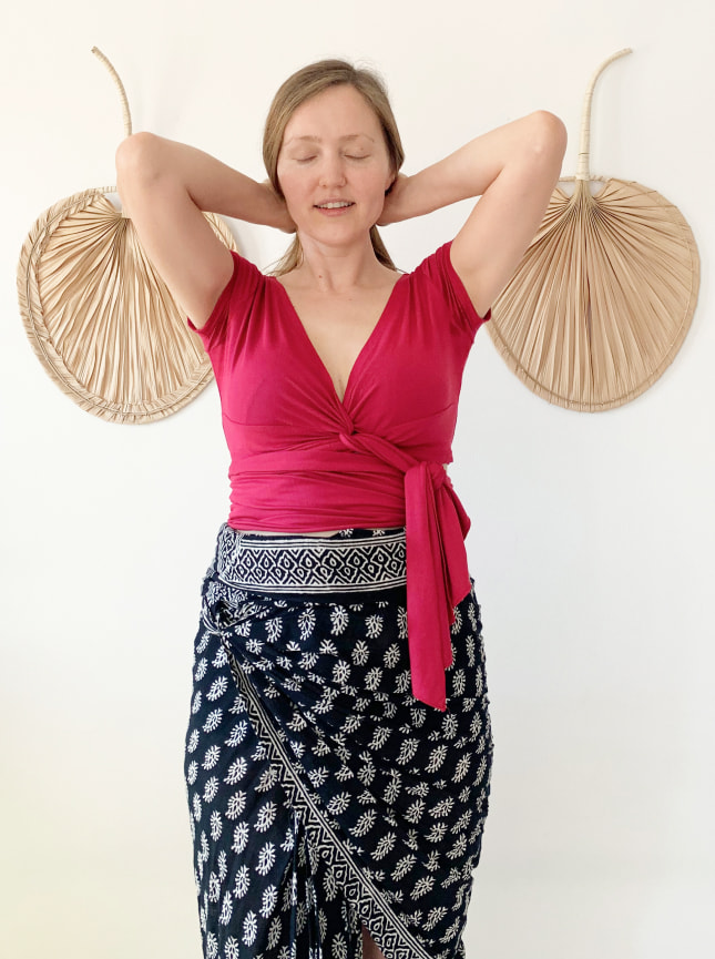 The ByGungur Pearl Crop top is a multiuse crop top that can be worn a number of ways. Here the model is wearing it with a plunging V neckline and with the extra material tied around the stomach / midriff area to give coverage to the waist. The model is wearing the Pearl Crop with the ByGungur Block Print wrap skirt