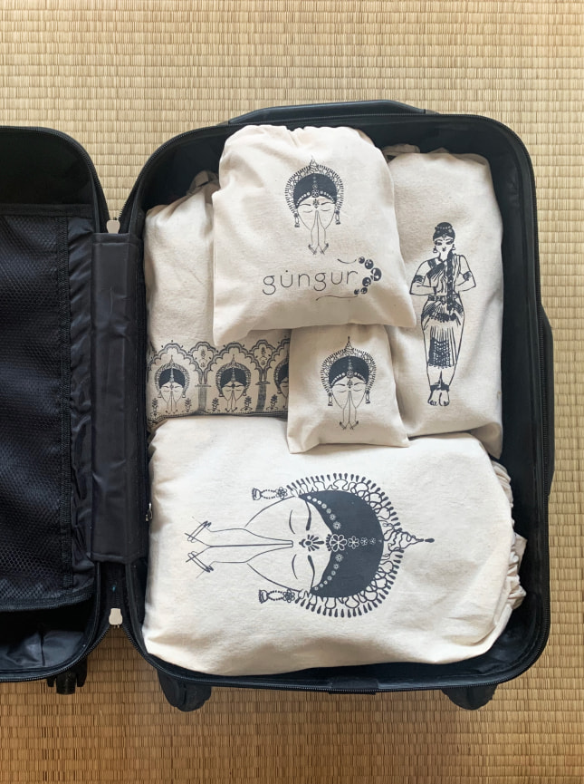 The ByGungur travel bags shown in use, full and packed into a suitcase ready for travel. Theses natural cotton travel bags are perfect to store jewellry, hair accesories, hygiene products and if you're an Indian classical dancer, your ghungeroos too. sizes: XL (40cm x 20cm) L (19cm x 30cm) M (25cm x 30cm) S (20cm x 20cm) XS (10cm x 15cm)