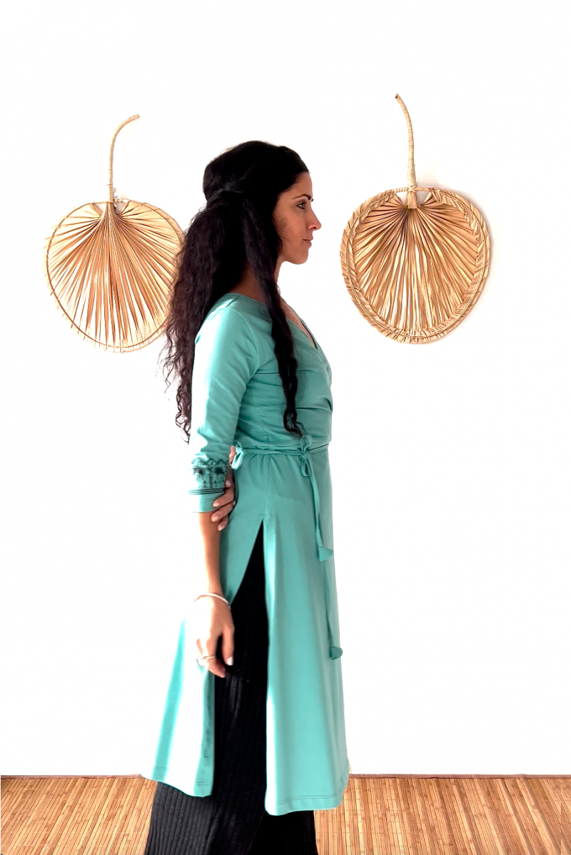 The ByGungur Lotus Kurta light blue is a long cotton wrap top with three quarter length sleeves. It is wraped around with a V neck at the front and tied at the back. Made of organic cotton it is light, breathable and comfortable. It can be worn as active wear or smart casual wear.