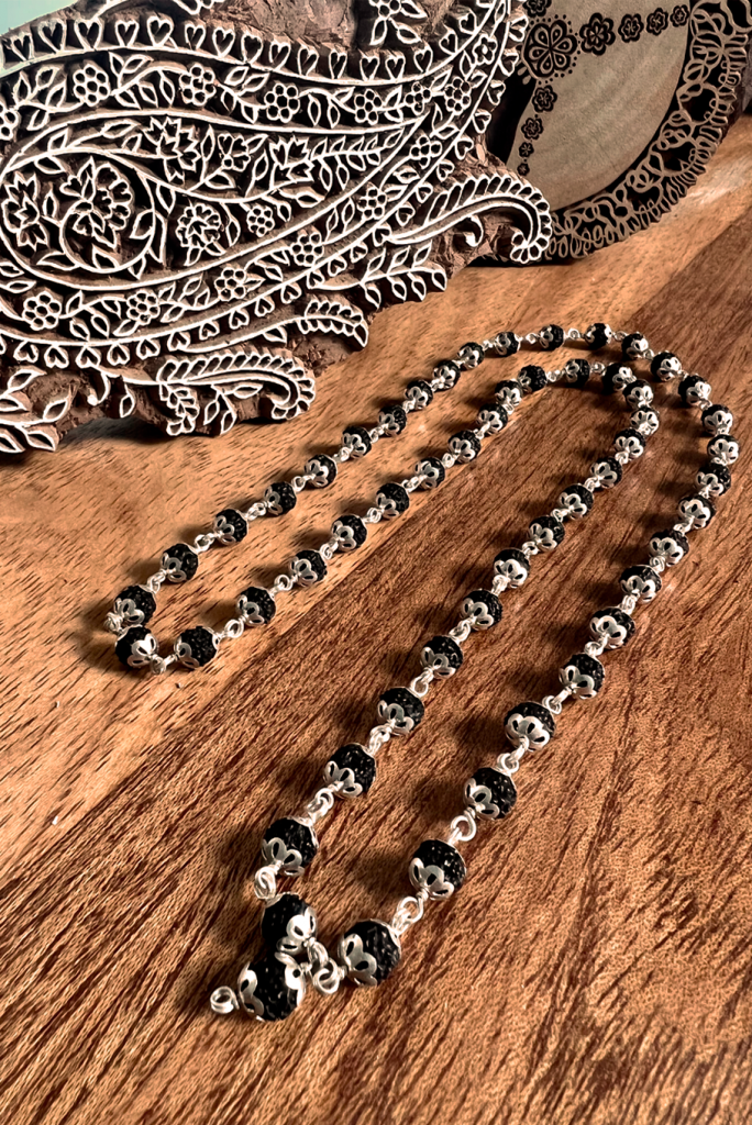 54 Rudraksha mala beads plus the guru bead. Genuine black Rudraksha stones are set by hand in Indian silver.