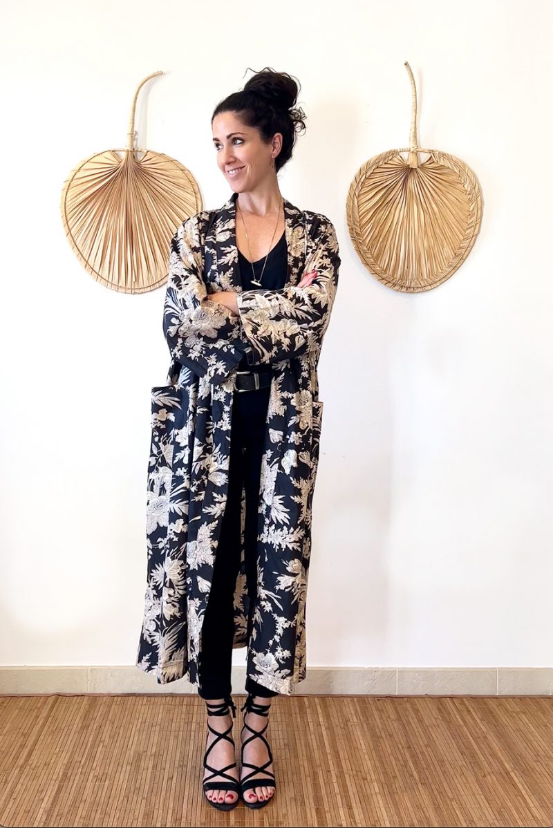 The Lily Kimo is a floral print kimono jacket made of 100% cotton. It has pockets and a belt which gathers at the back.