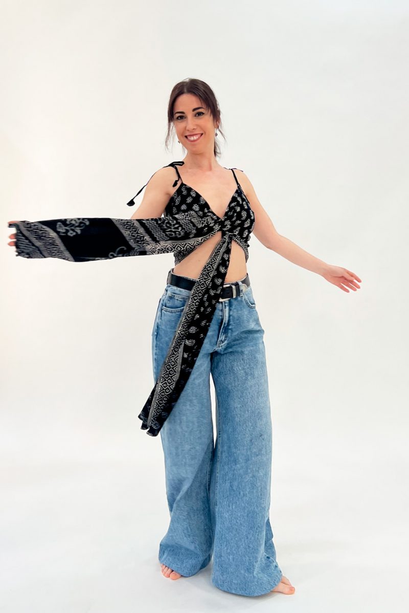 Here the model wears the Block Print Wrap Top in the cross over crop top style. The top is wrapped to give a cross over crop top look at the front with the long pieces of fabric hanging at the front. They can be left hanging or tied into a bow. The wrap top is made using hand made two tone block printed sarees. The wrap top is reversible and can be worn on the printed or plain side.
